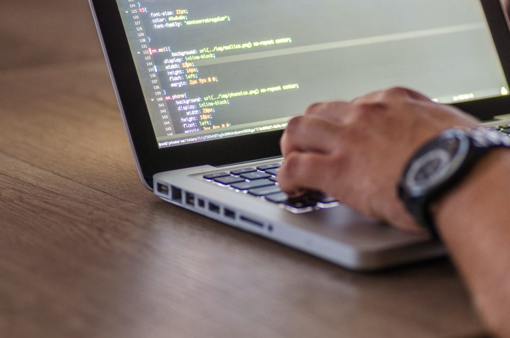 A Man Typing Code on the Computer