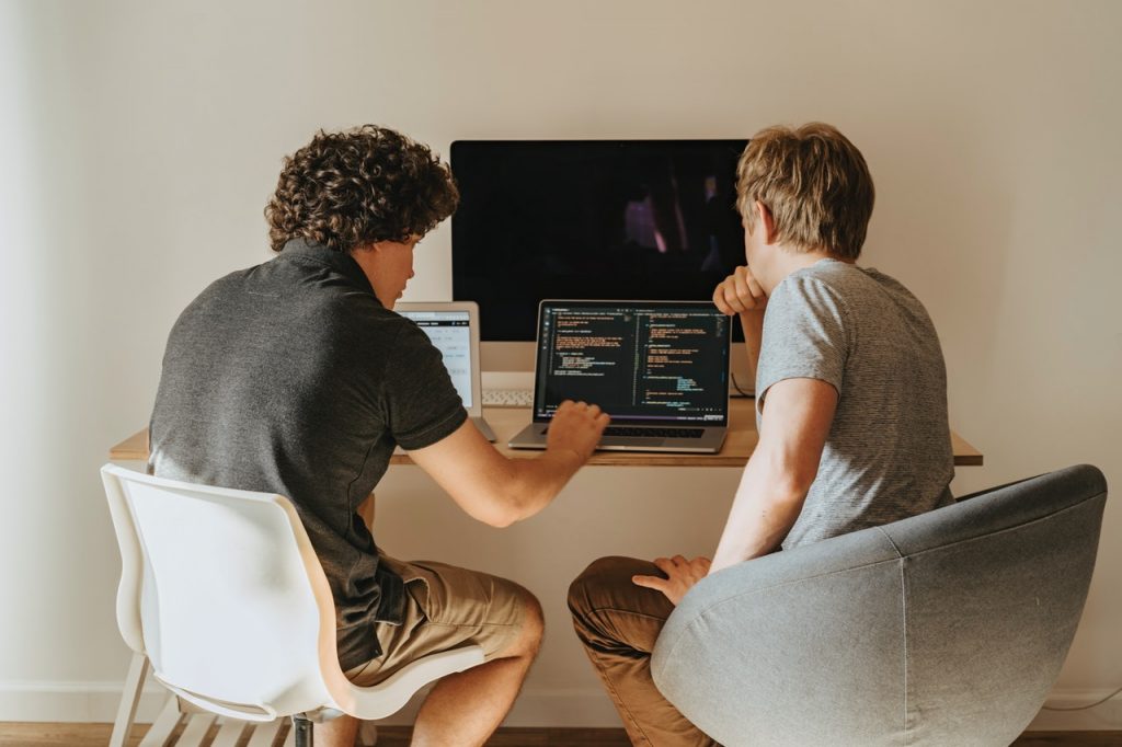 Two Men Sitting in Front of the Computer