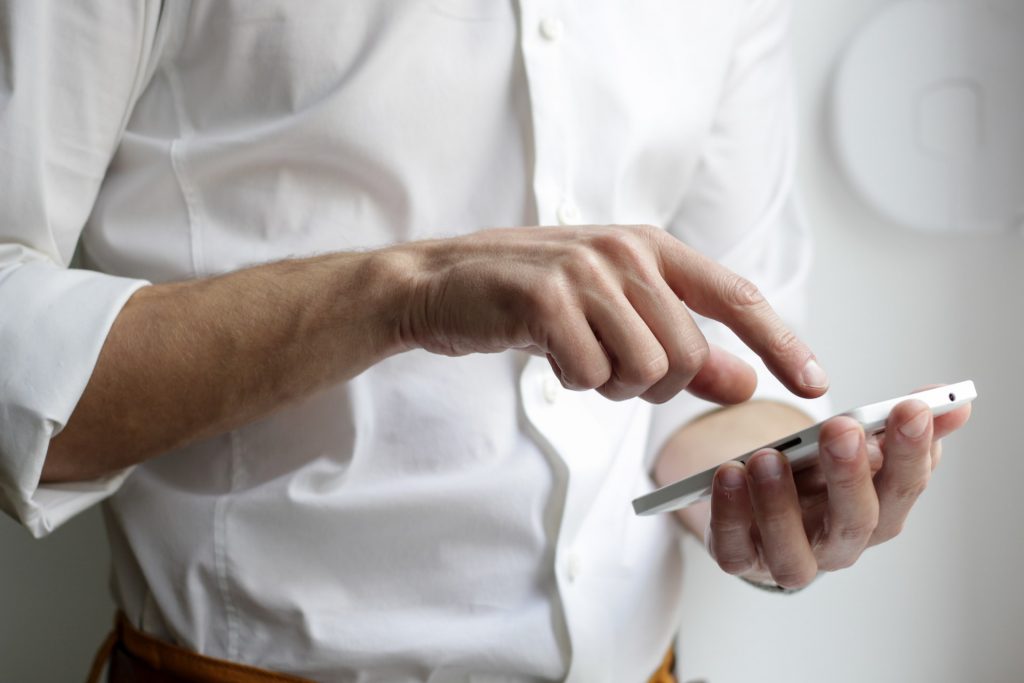 A Man Is Holding Mobile Phone