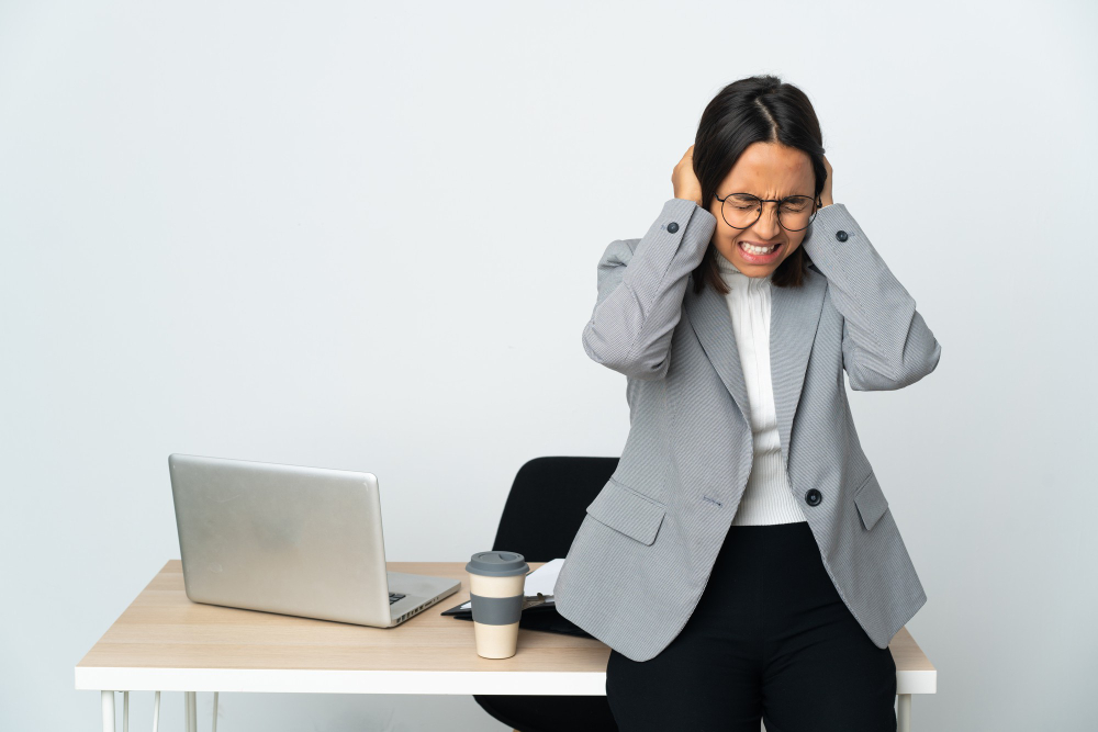 Woman Working in a Office Isolated on White Background Frustrated and Covering Ears