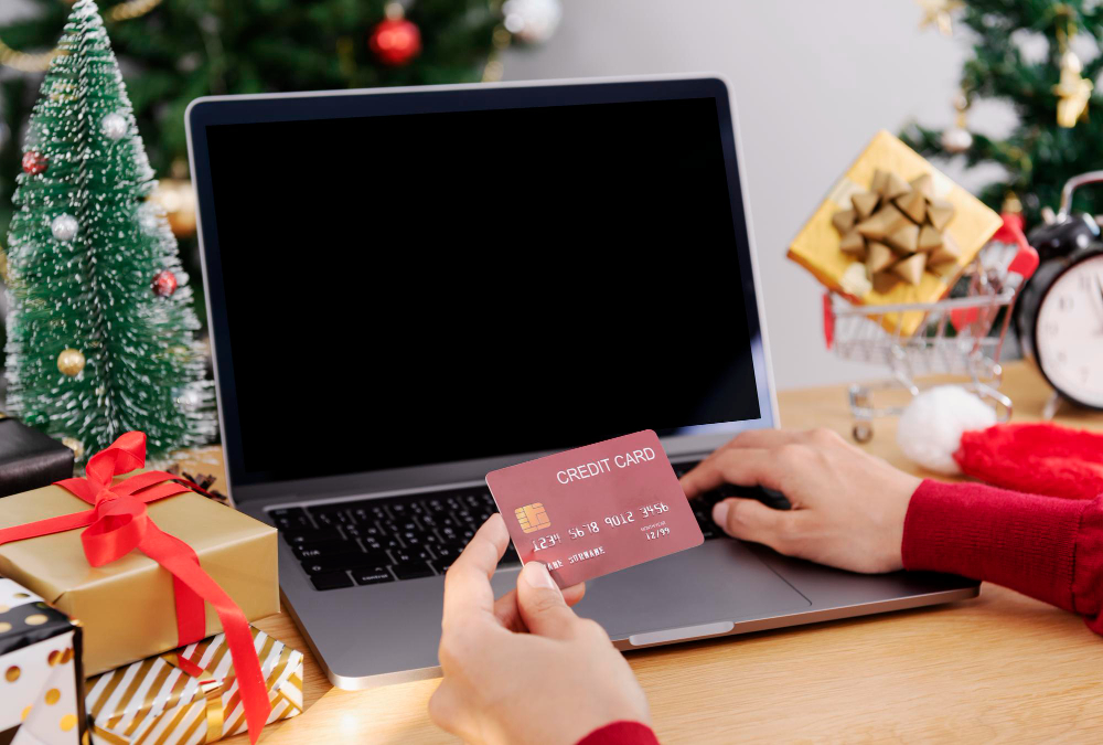 Happy Woman Holding Credit Card Doing Online Shopping Present at Christmas