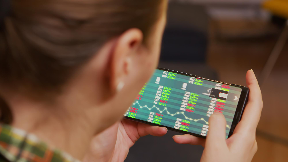 Back View of Woman Checking Stock Trading Using Smartphone