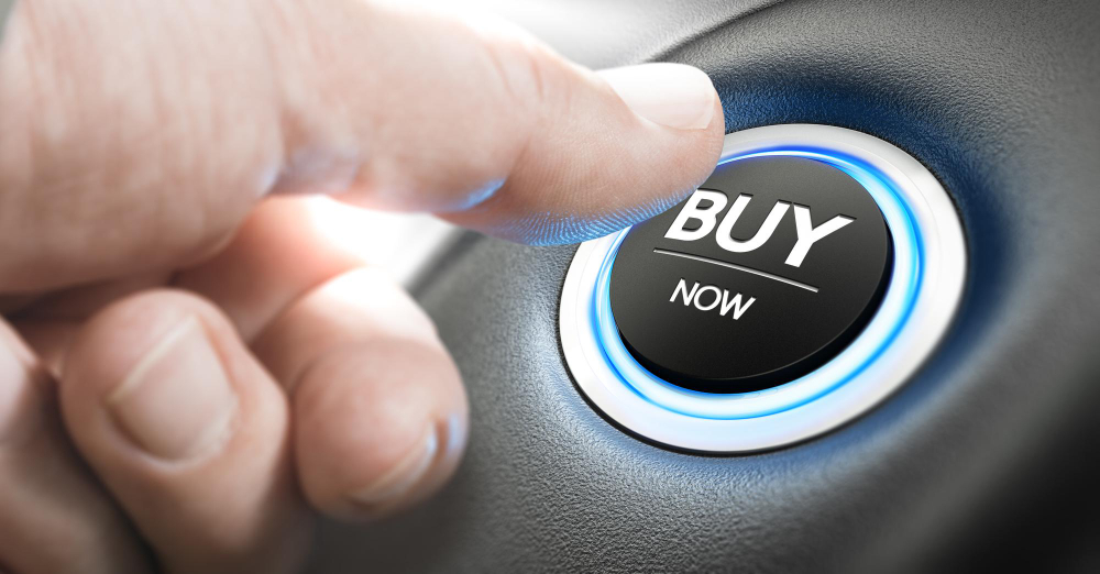 Man Pushing a Car Start Button With the Text Buy Now