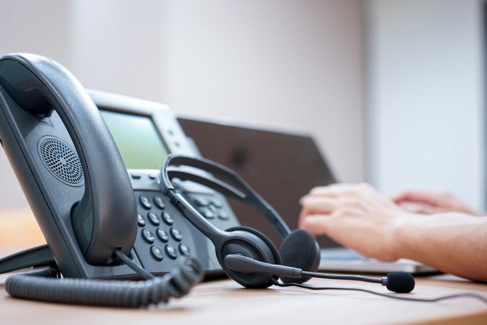 Headset With Blurred of Call Center Employee Hand Working in Operation Room 