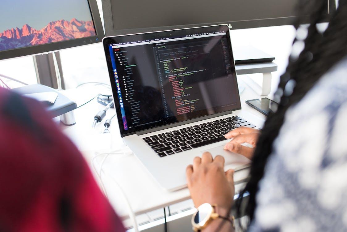 A Woman Is Typing Code on the Laptop