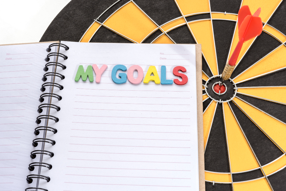 My Goals on Notebook With Dart Target Background