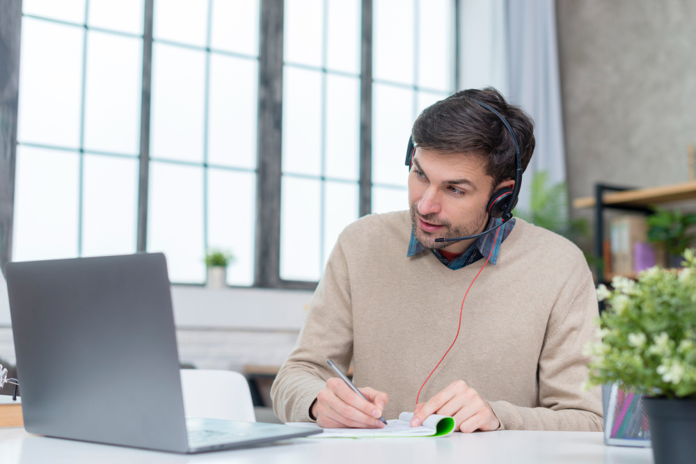 Man With Headphones Having an Online Meeting